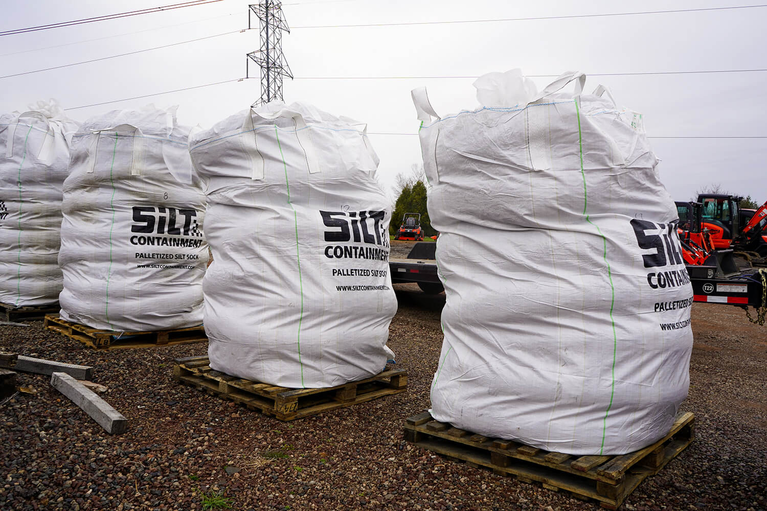 Palletized silt socks lined up in a row.